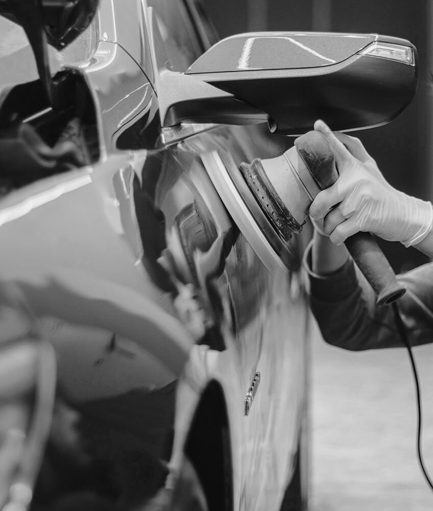 Man Polishing Car with Device